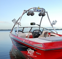 Red boat with a Monster Tower in the middle of the water.